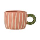 Coral pink stoneware cup with cream vertical stripes and a round olive green handle