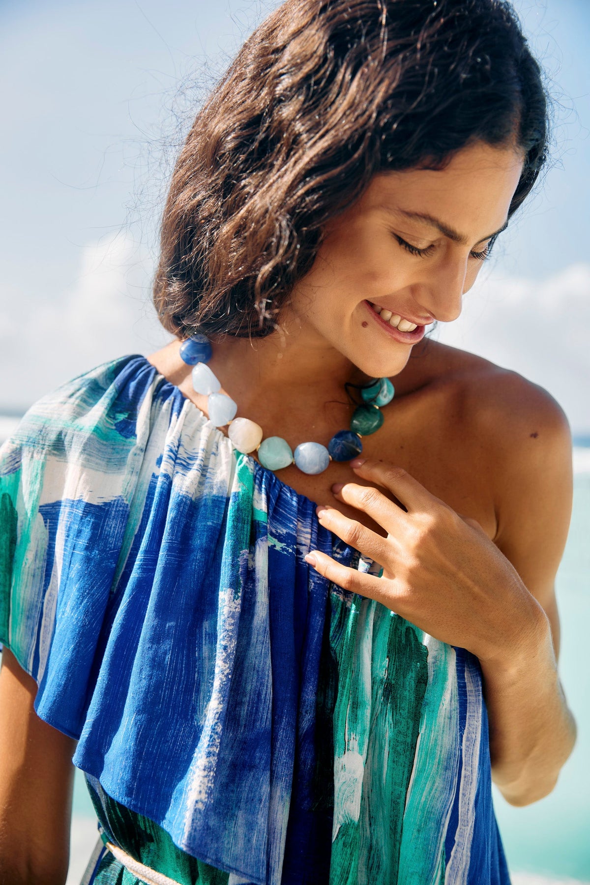 Close view of the Palmera Seafoam necklace at the collarbone, the beads in blues, greens and cream