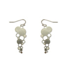 The Pearls of Wisdom earrings on white: cascades of silver steel circles on hooks.