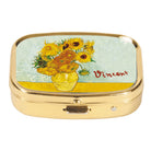 Gold-tone metal pill box with Van Gogh's Sunflowers in a yellow vase, signed Vincent, set in the lid.