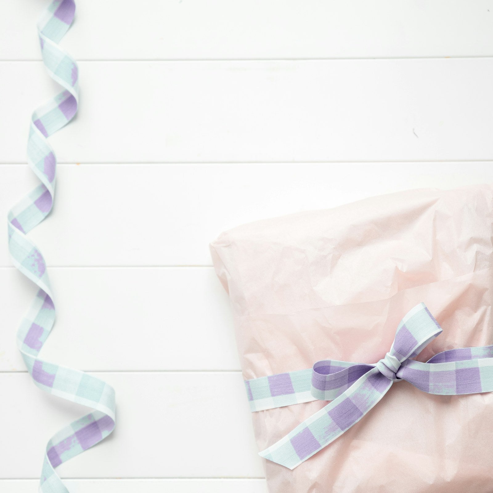 Gift wrapped in blush tissue with lavender gingham ribbon