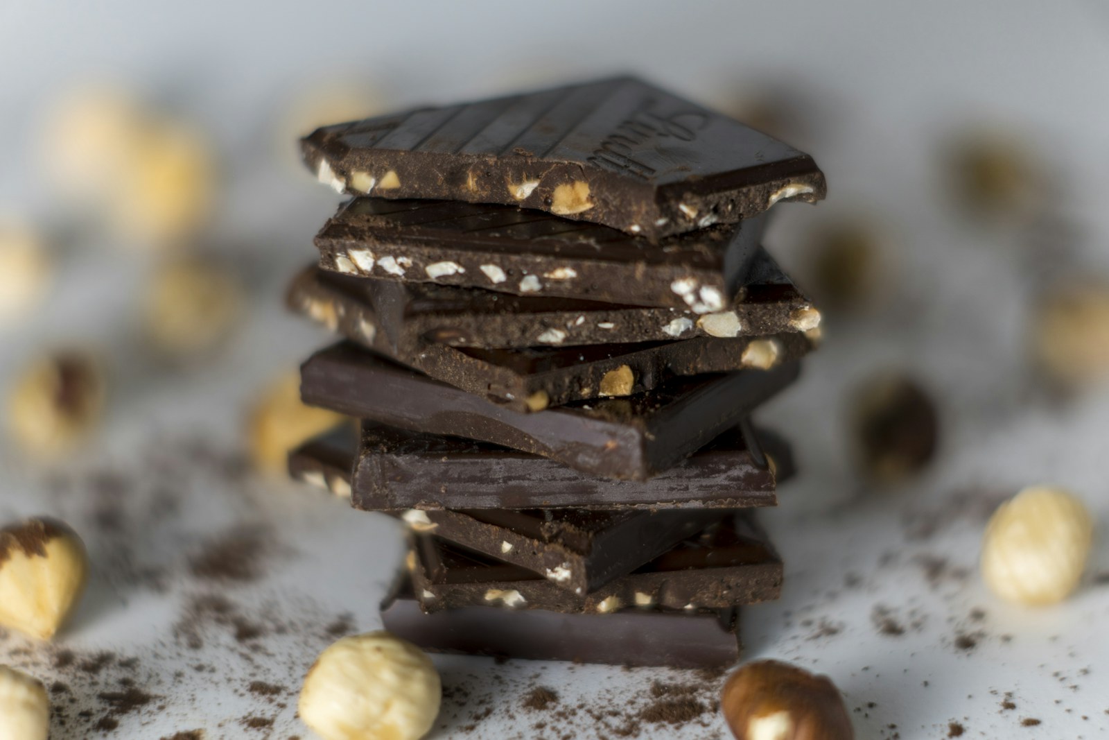 Stacked chocolate squares with hazelnuts, close up
