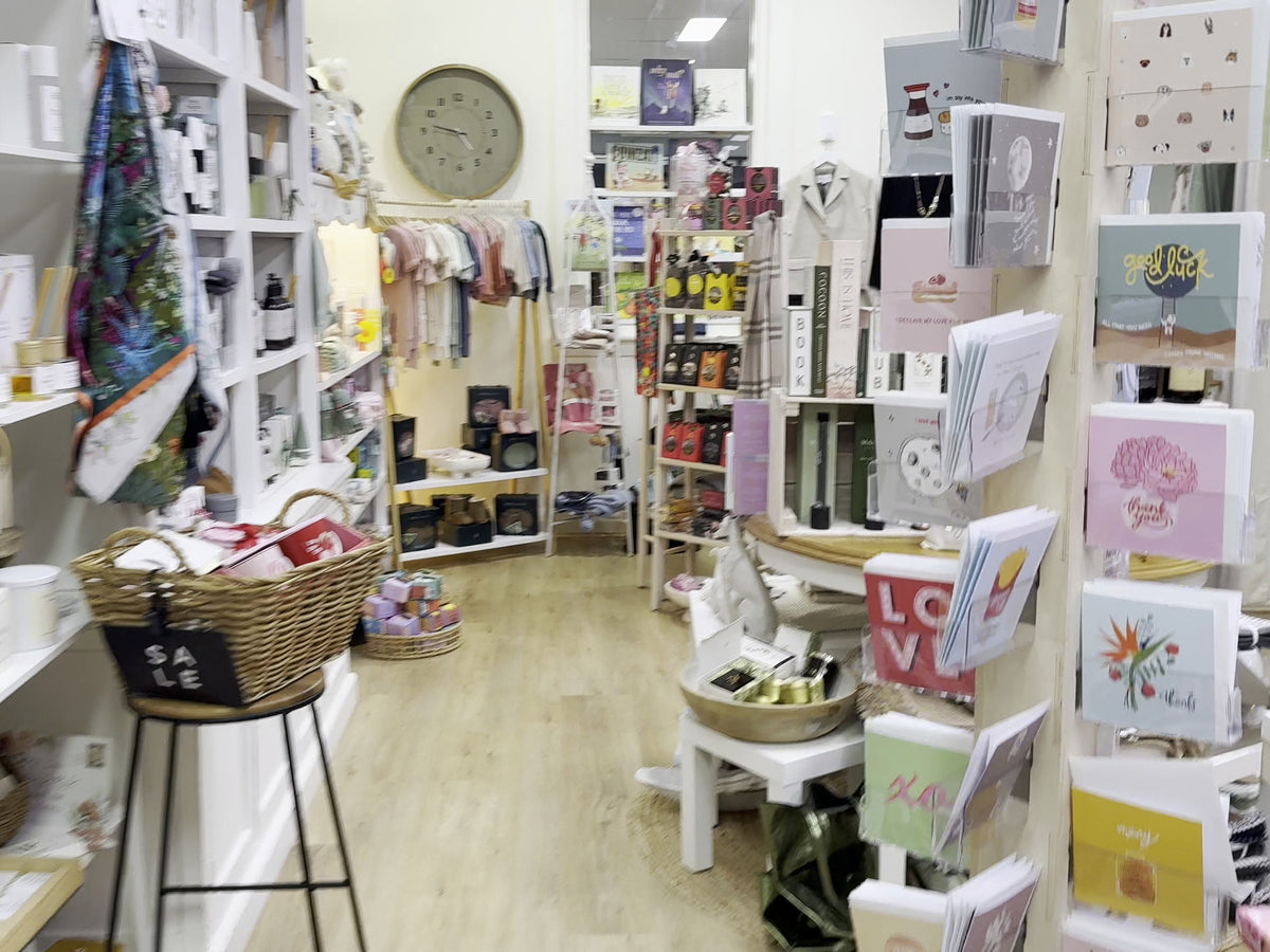The aisle, gift shelves and card stands inside Purple Merchant in Mortdale