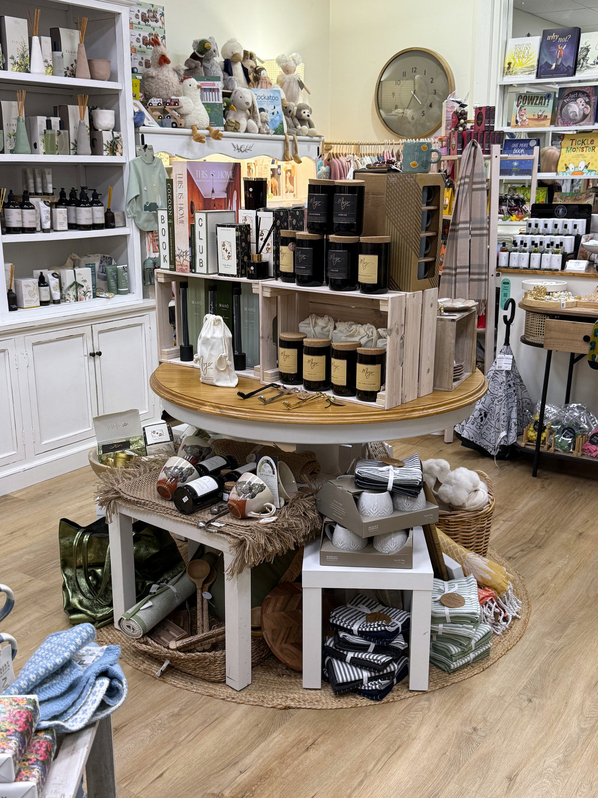 Candles, diffusers and small gifts on the round timber display inside Purple Merchant in Mortdale