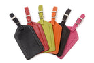 Luggage tags fanned out in black, red, lime, orange, dark brown and pink, straps and buckles at the top