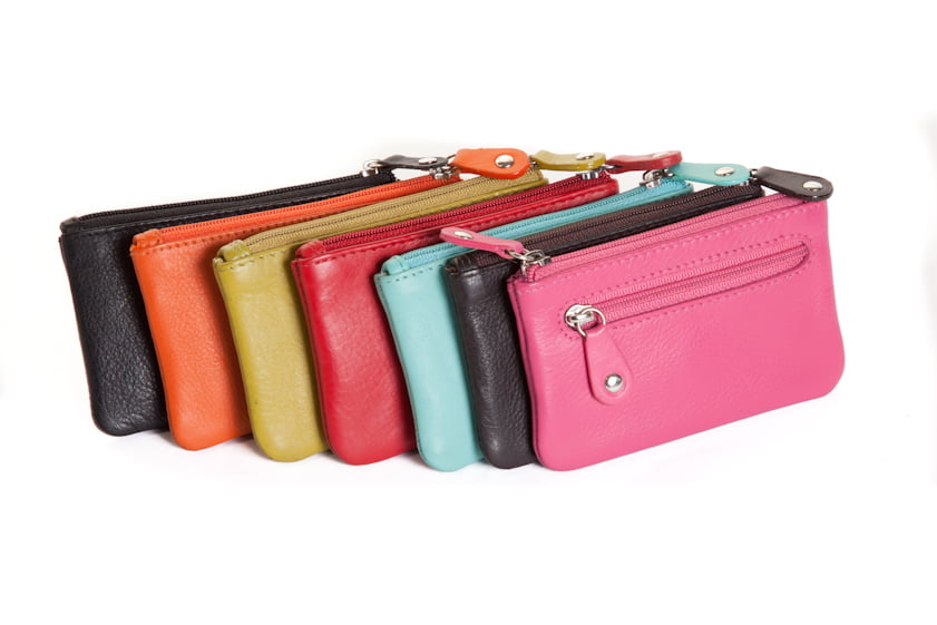 Flat leather coin purses fanned out in black, orange, lime, red, aqua and pink, zips facing up