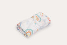 The Rainbow muslin wrap rolled and tied with white cotton tape.