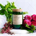 Rose, Pepper & Blackmint candle in a green reclaimed wine bottle with mint, roses and pink peppercorns