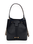 Front of the black Ruby bucket bag showing the drawstring tie, gold-tone logo plate and leopard-print side tassels