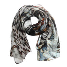 Safari Palm silk scarf in loose folds, a black, brown and white animal print