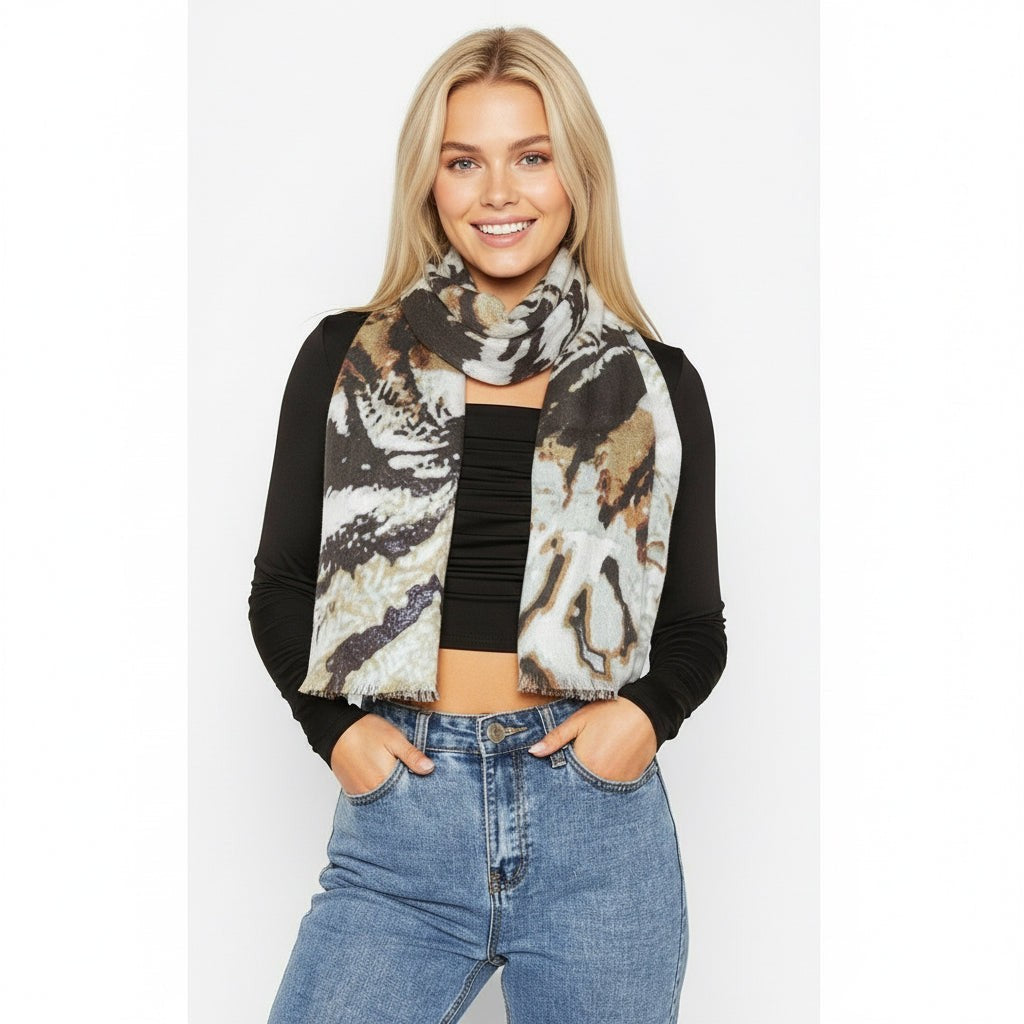 Safari Palm silk scarf worn knotted at the neck with a black top and jeans