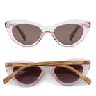 Savannah Blush Pink sunglasses front-on and folded from above, a clear pink cat-eye frame with striped walnut arms