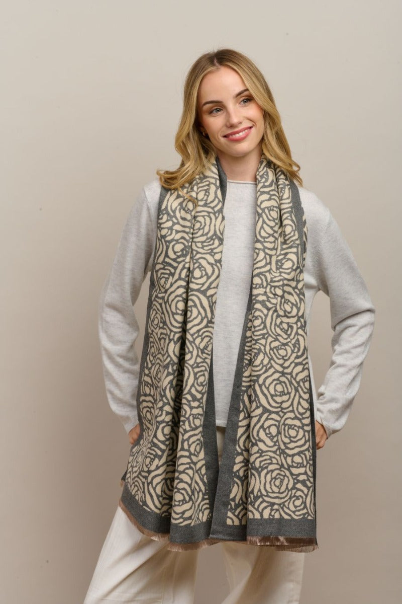 Model wearing the grey Wild Rose scarf draped over a grey jumper