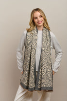 Model wearing the grey Wild Rose scarf draped over a grey jumper