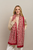 Model wearing the red Wild Rose scarf with a cream knit