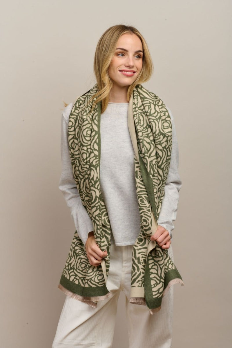 Model with the green Wild Rose scarf over a light grey jumper