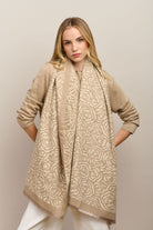 Model wearing the latte Wild Rose scarf draped long over a beige knit