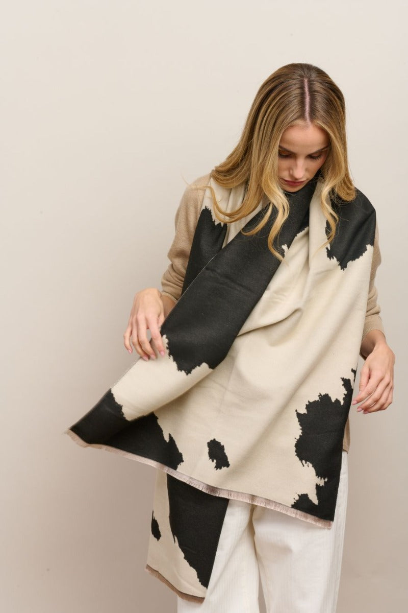 Model wearing the black and cream cow-print Ranch scarf