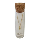 Selina gold-plated sterling silver letter F initial necklace in its cork-topped glass gift tube