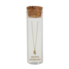 Selina gold-plated sterling silver letter N initial necklace in its cork-topped glass gift tube