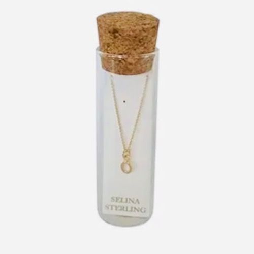 Selina gold-plated sterling silver letter O initial necklace in its cork-topped glass gift tube
