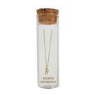 Selina gold-plated sterling silver letter R initial necklace in its cork-topped glass gift tube