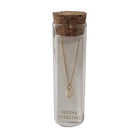 Selina gold-plated sterling silver letter U initial necklace in its cork-topped glass gift tube