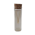 Selina gold-plated sterling silver letter X initial necklace in its cork-topped glass gift tube