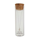 Selina sterling silver letter E initial necklace in its cork-topped glass gift tube
