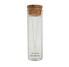Selina sterling silver letter H initial necklace in its cork-topped glass gift tube