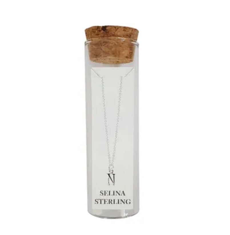 Selina sterling silver letter N initial necklace in its cork-topped glass gift tube