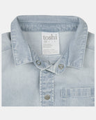 Close-up of the collar, press studs, chest pocket and the composition label reading 70% cotton, 27% polyester, 3% elastane