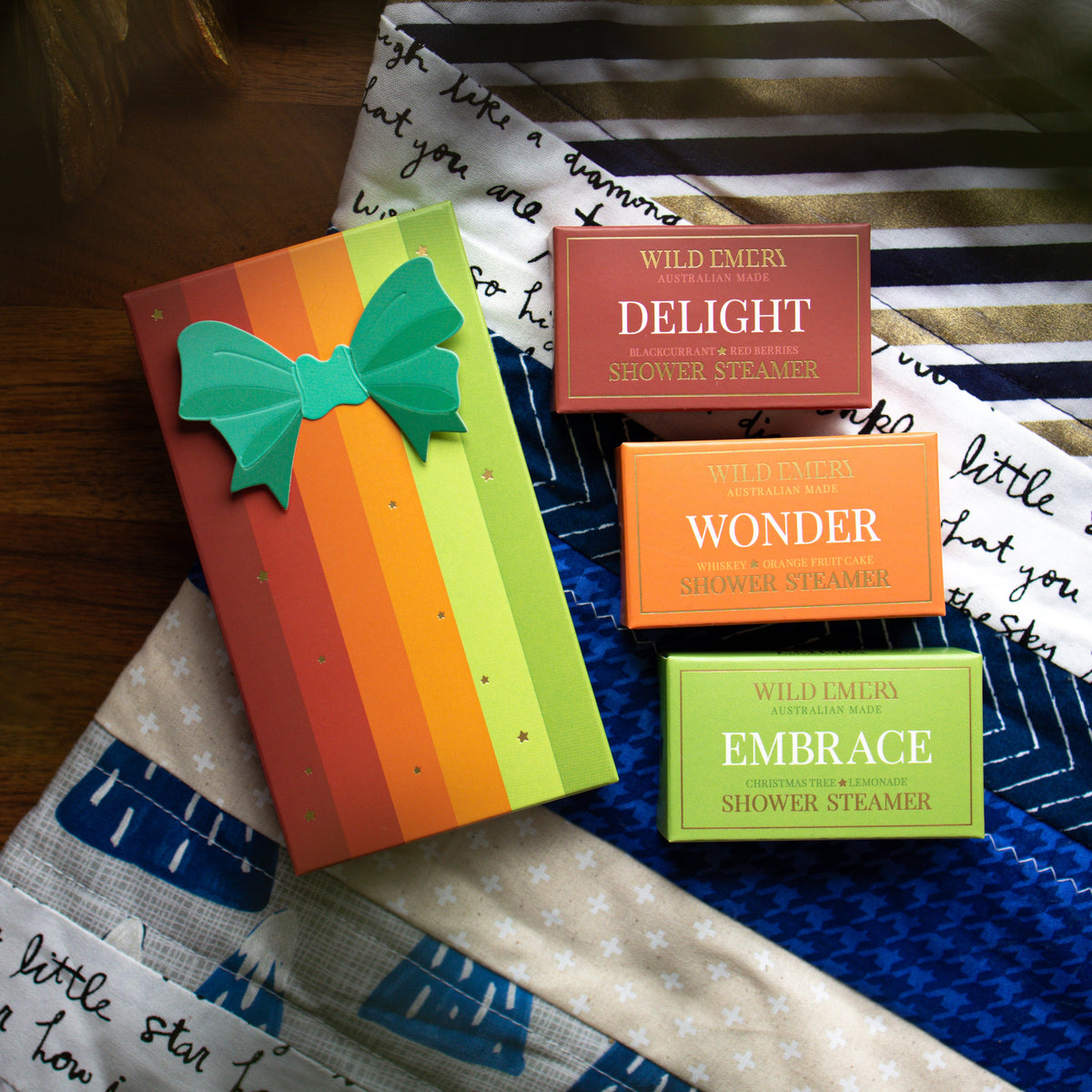 The Warm and Bright gift box beside its three boxed steamers: Delight, Wonder and Embrace.