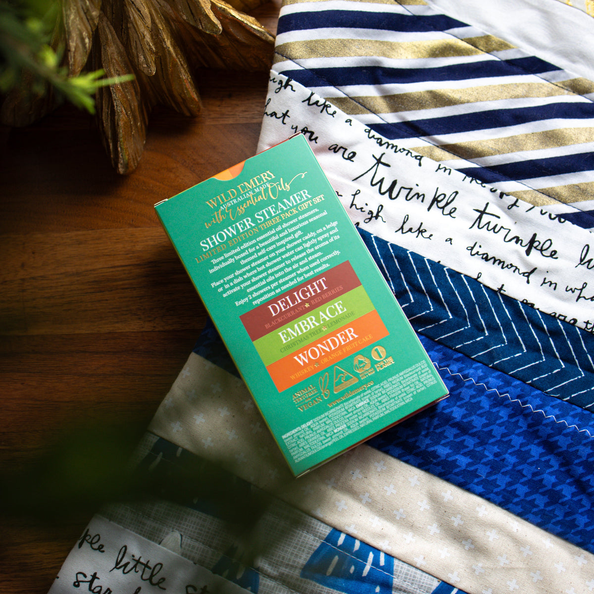 The back of the Warm and Bright box, listing Delight, Embrace and Wonder and their scents.