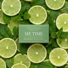 Green Me Time shower steamer box on a bed of lime slices and mint leaves.