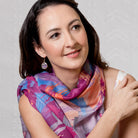 Sunrise scarf in pink worn over the shoulders