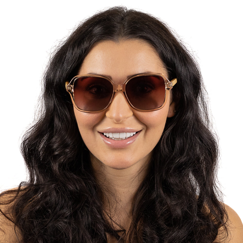 Dark-haired model smiling straight to camera in the Scarlett champagne square sunglasses