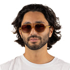 A man with dark curly hair wearing the Billy sunglasses, front on