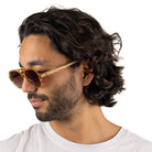 A man with dark curly hair in profile wearing the Billy sunglasses