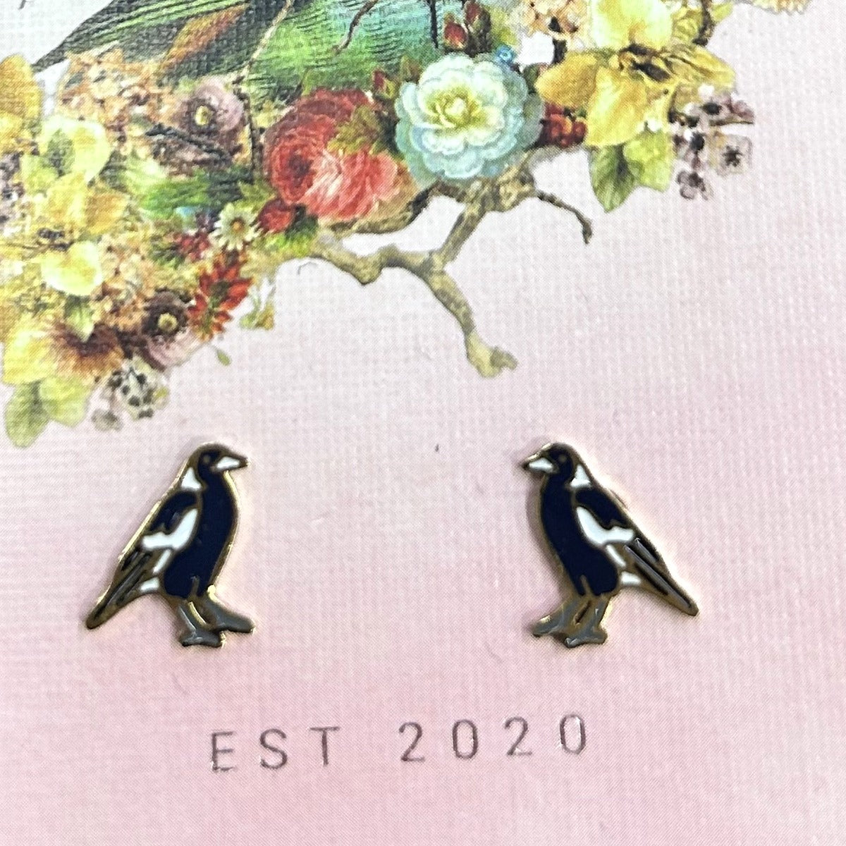 Black and white magpie stud earrings on a pink Songbird and the Bee card