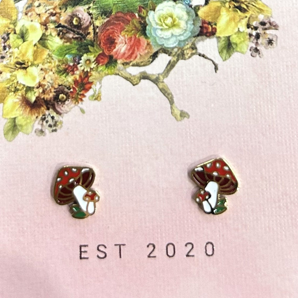 Red spotted toadstool stud earrings on a pink Songbird and the Bee card
