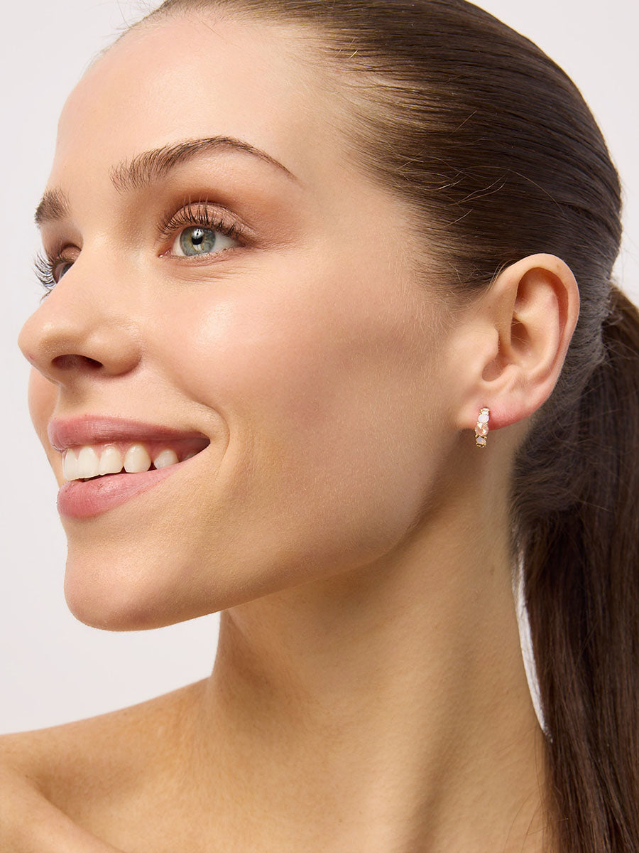 Smiling model with slicked-back hair wearing a Pink sparkle half hoop
