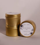 Three gold Sunflower travel tins, one tipped forward to show its lid label with a drawing of the sunflower.