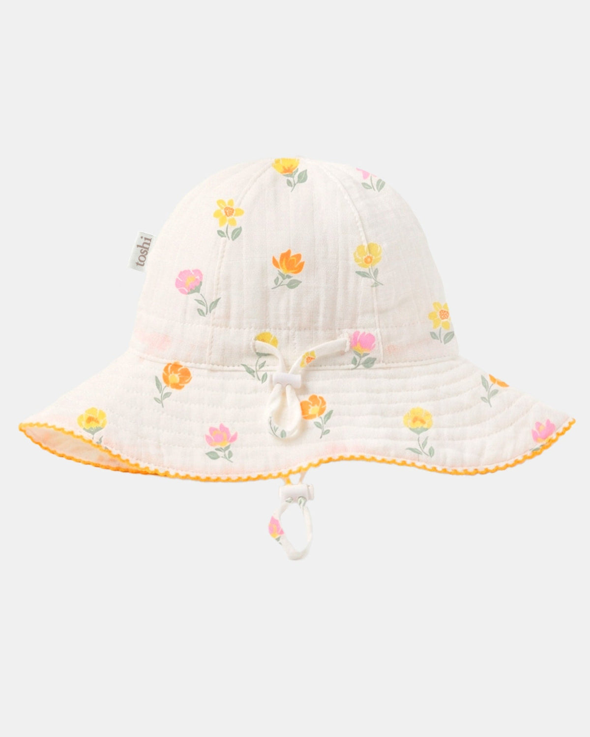 Toshi Pippa sunhat in vanilla cotton with a yellow, orange and pink blossom print, a wavy yellow-edged brim and chin toggle