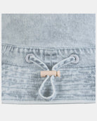 Close-up of the adjustable cord toggle at the back of the hat