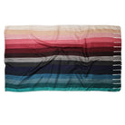 The Sunset Spectrum Stripes scarf laid flat, stripes running from cream through rose and wine to navy and teal