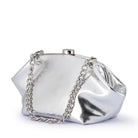 Silver clutch at an angle, its chunky chain handle draped down the front