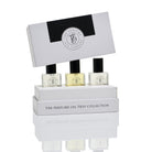 The grey trio box with its lid lifted over the three perfume oil bottles.