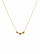 Fine gold-tone chain with three small textured gold-tone hearts side by side, the middle one larger
