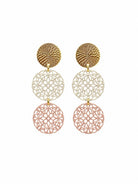 Pair of long drop earrings: a textured gold-tone disc, a white filigree disc and a dusty pink filigree disc